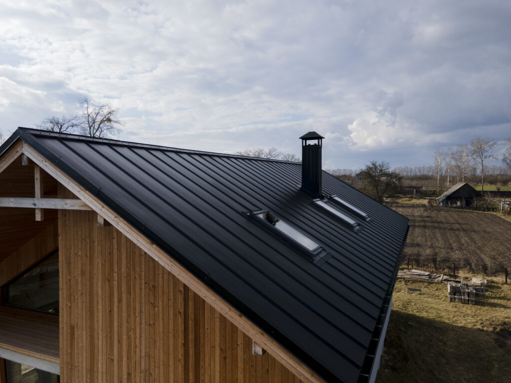 Black standing seam metal roof.